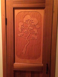 Rubus Woodworks Custom cedar pantry door with hand carved Arbutus tree silhouette