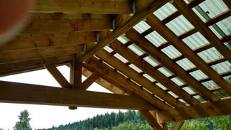 Rubus Woodworks Craftsman-style roof system  built over hot tub and bbq area